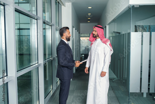 Arabian Businessman with a foreign businessman discussing work in a modern office  photo