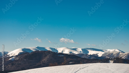 Beautiful shot of snowy mountain peaks under a blue sky in Slovakia © Wirestock Creators