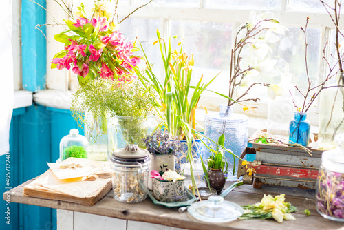 Vintage cupboard on veranda on sunny spring day decorated with flowers, Easter retro decor and willow branches, Easter family celebration