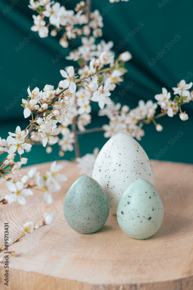 Easter eggs on a wooden background and blossoming plum branches. Easter concept Easter eggs on a wooden background and blossoming plum branches. Easter concept