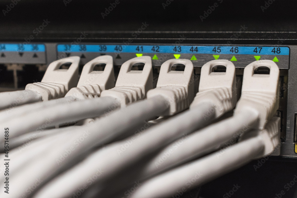 Detail of a network cables connected to a hub inside a telecommunications cabinet Detail of a network cables connected to a hub inside a telecommunications cabinet