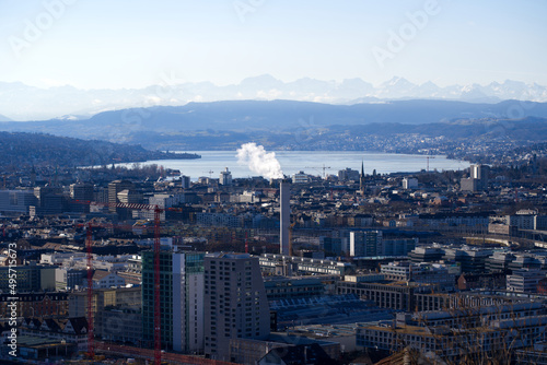 Aerial view over City of Zürich with Lake Zürich and Swiss Alps in the background on a blue and cloudy spring morning. Photo taken March 14th, 2022, Zurich, Switzerland.