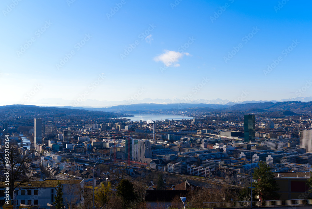 Aerial view over City of Zürich with Lake Zürich and Swiss Alps in the background on a blue and cloudy spring morning. Photo taken March 14th, 2022, Zurich, Switzerland.