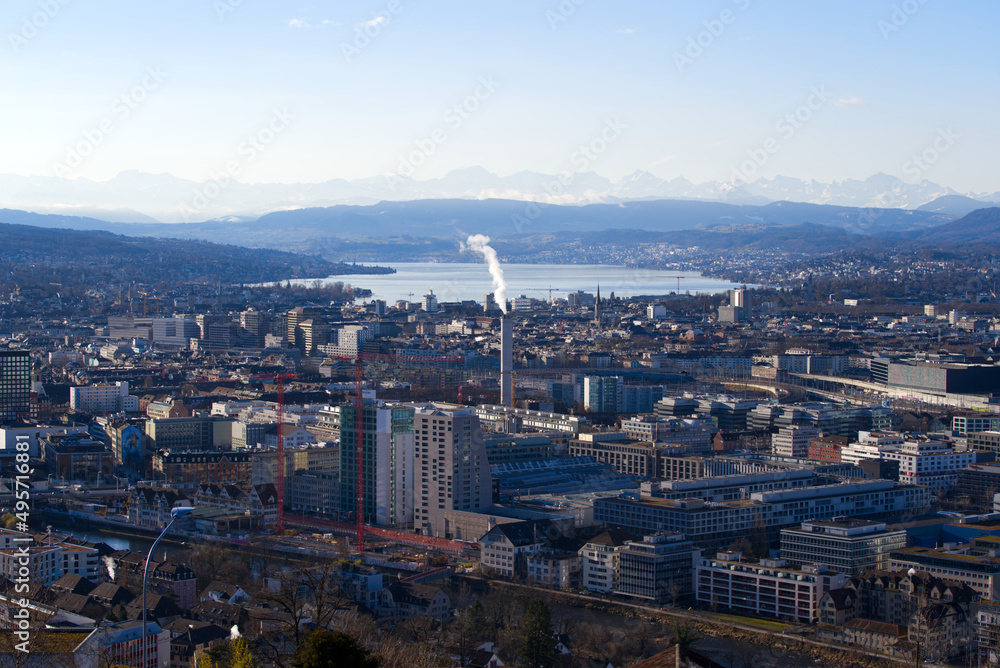 Aerial view over City of Zürich with Lake Zürich and Swiss Alps in the background on a blue and cloudy spring morning. Photo taken March 14th, 2022, Zurich, Switzerland.