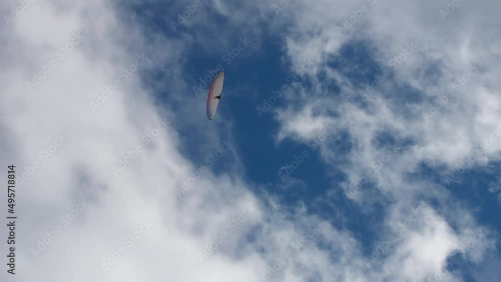 Paraglider flying against the blue sky full of beautiful clouds. Extreme sports activities concept. Paraglider flying against the blue sky full of beautiful clouds. Extreme sports activities concept.