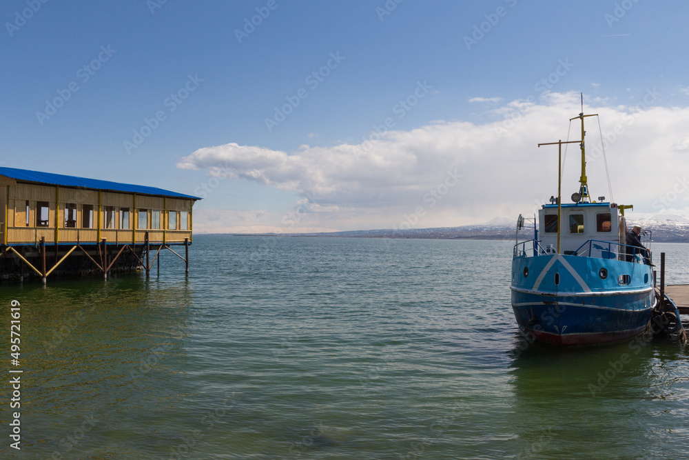The blue ship stands at the pier of Lake Sevan. Armenia