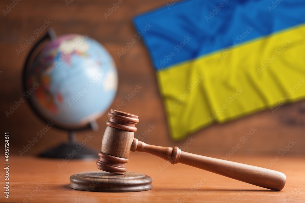 Judge's law gavel with flag of Ukraine on desk