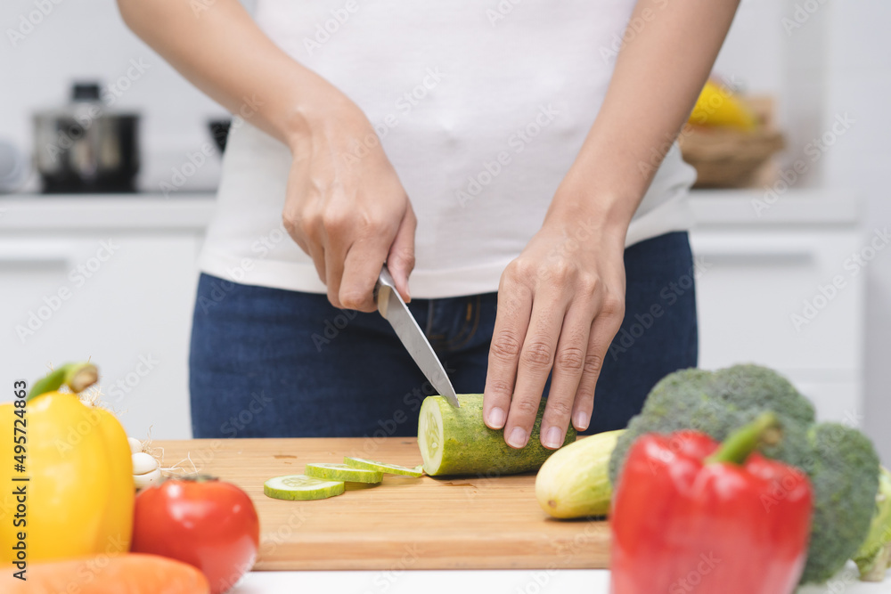 Close up woman preparing ingredient for salad.