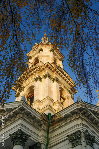 Bell tower of Holy Trinity Cathedral in Sumy, Ukraine illuminated with golden sunset light