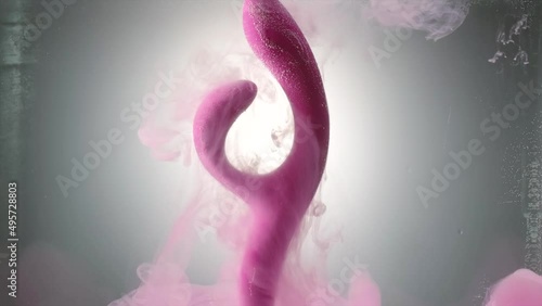 Vibrator for woman. Creative. Sex toy or vibrator to satisfy woman. Stylish vibrator for woman in water. Advertising of sex toys and vibrators photo