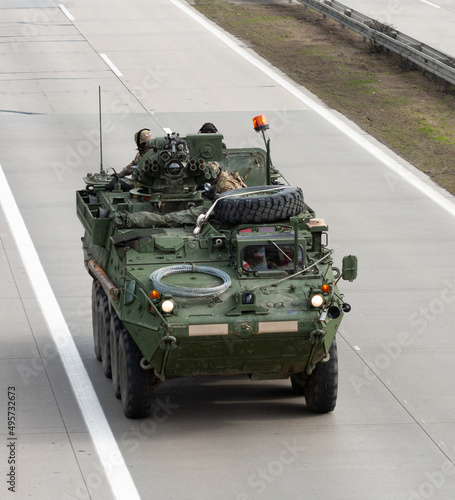 US army military convoy passes  in Czech Republic. Strykers, wheeled armored vehicle drives on highway . photo