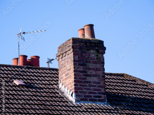 Print op canvas chimney and chimney pots on a tiled roofed house