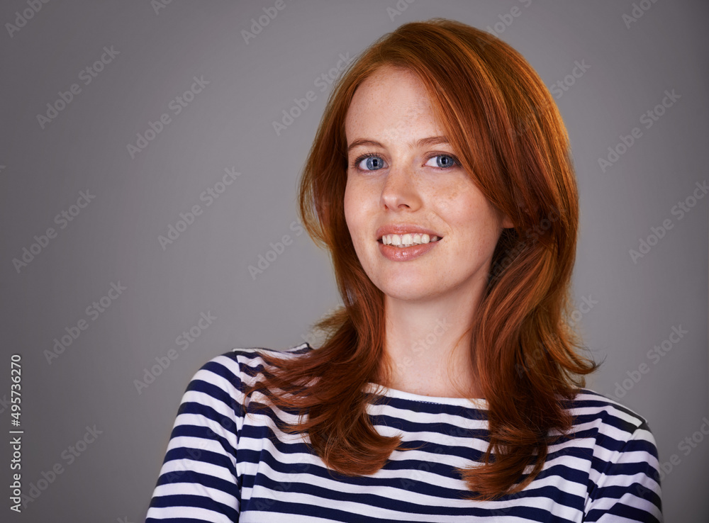 Find happiness wherever you are. Studio portrait of an attractive woman against a gray background. Find happiness wherever you are. Studio portrait of an attractive woman against a gray background.