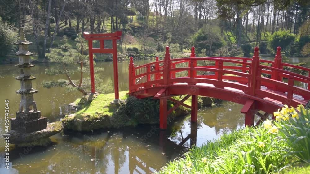 view on a beautiful red bridge in a park view on a beautiful red bridge in a park