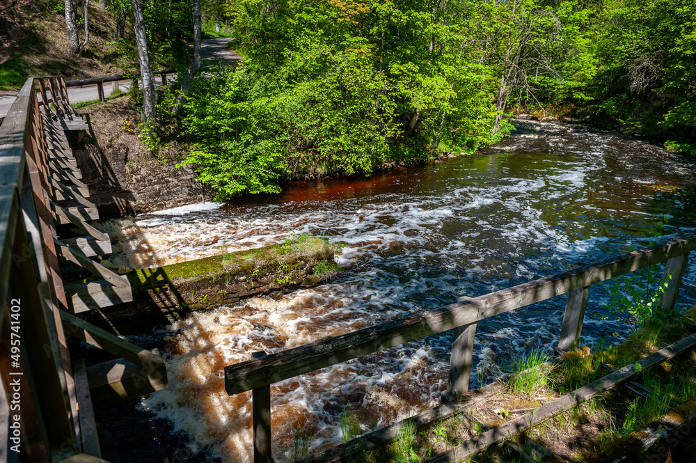 Obraz premium Ruins of Nommeveski hydroelectric station. Spring landscape with a fast river. Nõmmeveski, Estonia.