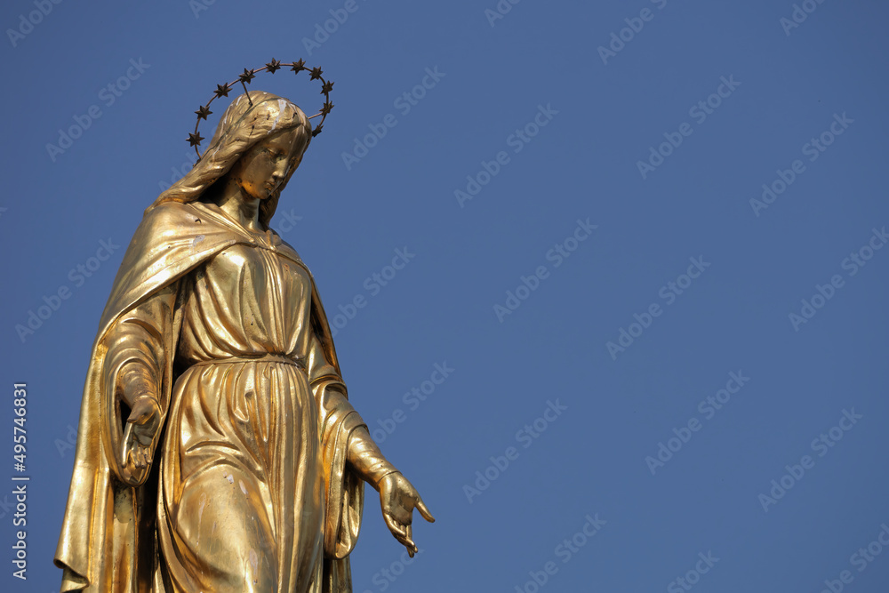 Close-up of a Holy Mary statue placed on top of a column in front of Zagreb Cathedral, Croatia