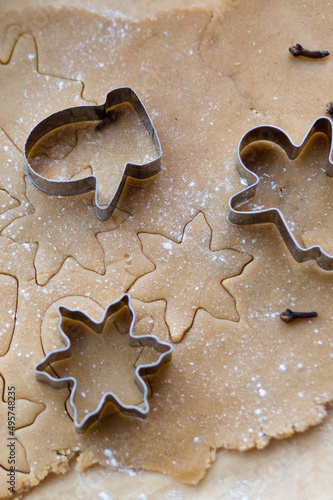 Rolled ginger dough on the table with Christmas cookie cutters. Silhouettes on the test. Christmas Cookies viewed from above