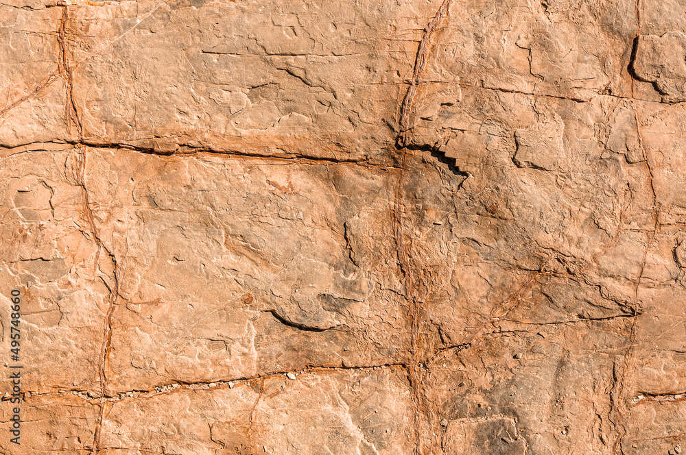 Stone Old Wall of stone close-up. Natural stone background. High resolution brown natural stone surface. Rustic textured stone for wallpaper.