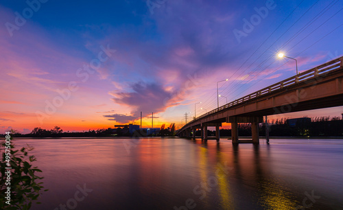 Bridge over the river in the evening,The light from the lamp to the reflector surface,Container Terminal in Hamburg, Germany. Bridge is called Koehlbrandbruecke - a bridge about the harbor. 