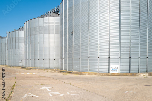 Wallpaper Mural Grain storage silos seen at a grain storage facility. Direction signs can be seen on the road for routing truck distribution to and from the facility. Torontodigital.ca