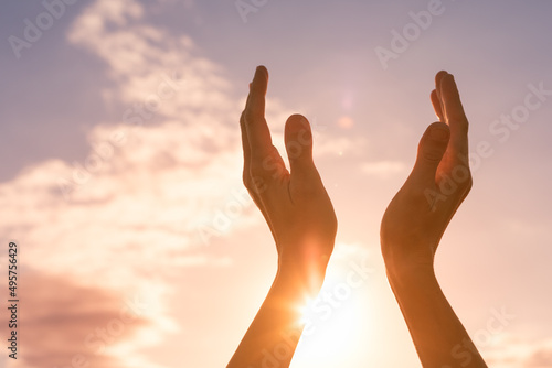 worshiping hands up to the sun light sky. Positive energy, prayer and gratitude concept. 