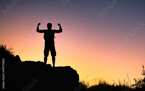 Strong fit man. silhouette of a person on the top of mountain