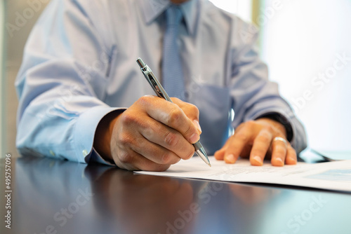 Businessman signing a document in the office