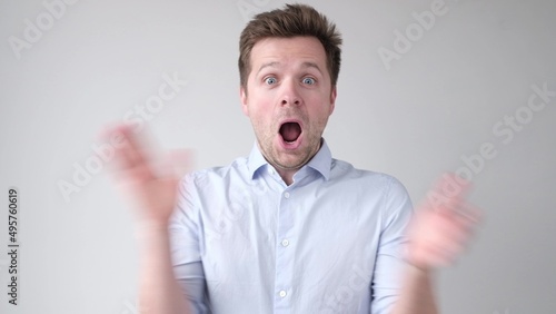 Caucasian young man being surprised with positive news.