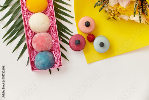 Принти на полотні Japanese dessert wagashi and French dessert macaroons lie on a bright background