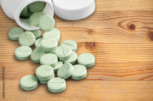 Tablets for radiation protection on the wooden table with a plastic medical jar photo