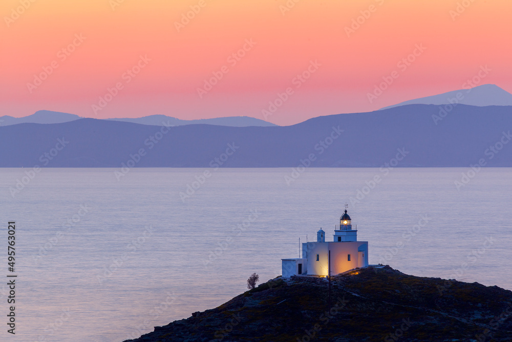 Beautiful sunset with the lighthouse of Vourkari village, in Kea (or Tzia) island, in Cyclades islands, Aegean Sea, GREECE, Europe