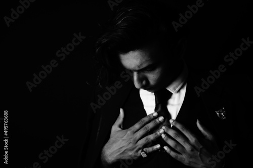 Grayscale shot of an Indian man posing in a classic outfit