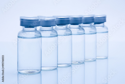 Closeup of medicine or injection vials in a row isolated on a white background photo