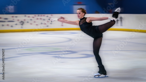 Woman doing a nice figure in ice skating with motion blur effect