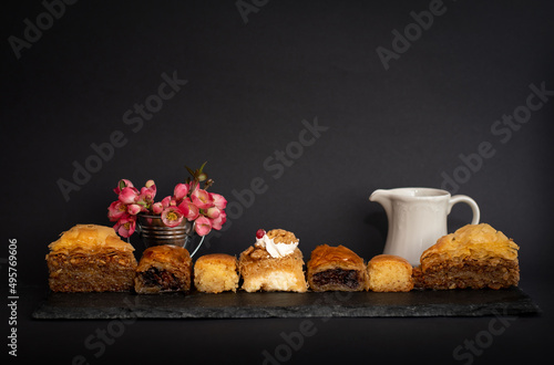 Baklava, Kadaif, Kalburabasma is a dessert dish of the peoples of the Balkan Peninsula. on a black background  photo