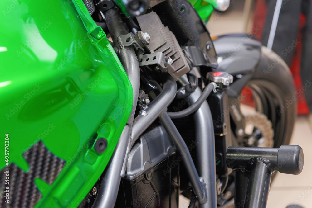 The master performs maintenance on the motorcycle. The master performs maintenance on the motorcycle.