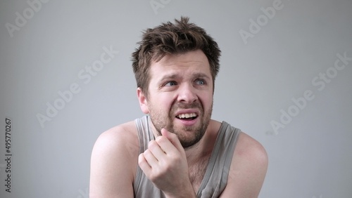 Caucasian nervous man looking around having hallucinations. photo