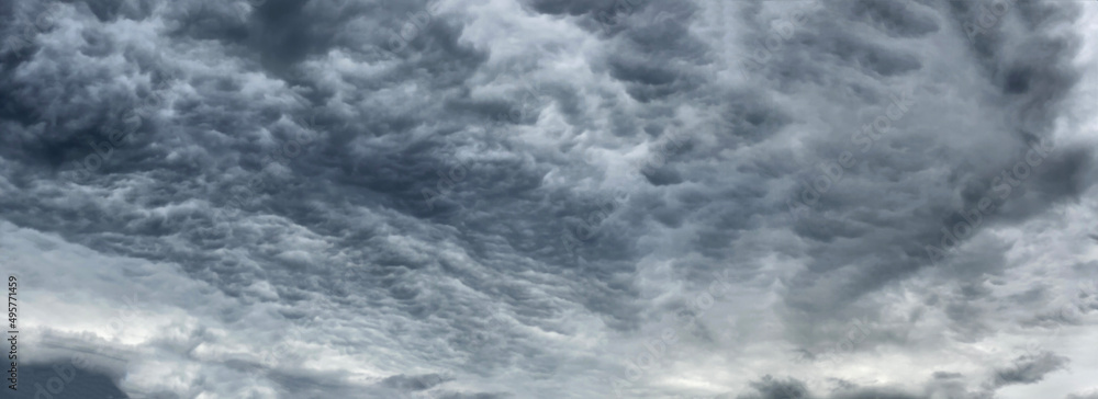 Dark blue cloudy sky with low clouds