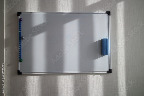 White magnetic drawing board on the wall