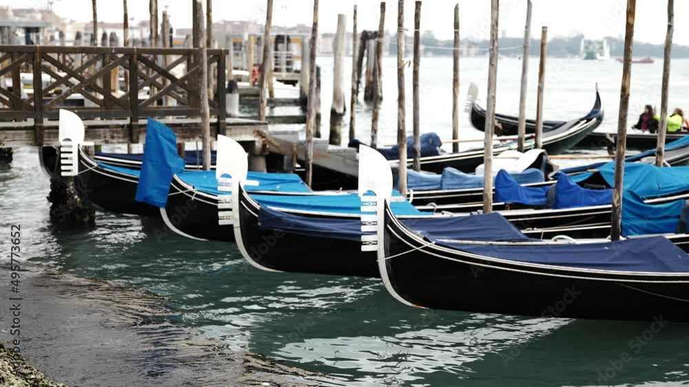 Venice, Italy - gondolas and gondoliers in the Grand Canal near the Rialto Bridge, in the San Marco Basin and between the canals of the lagoon city Venice, Italy - gondolas and gondoliers in the Grand Canal near the Rialto Bridge, in the San Marco Basin and between the canals of the lagoon city