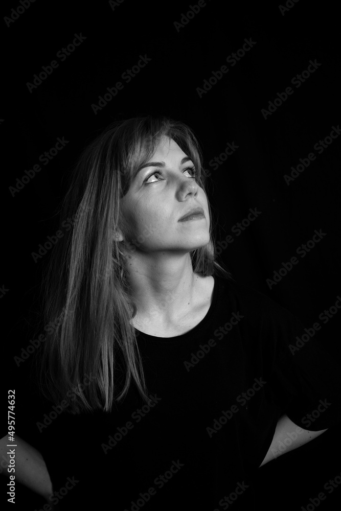 Young beautiful girl looking up. Black and white photo. Young beautiful girl looking up. Black and white photo.