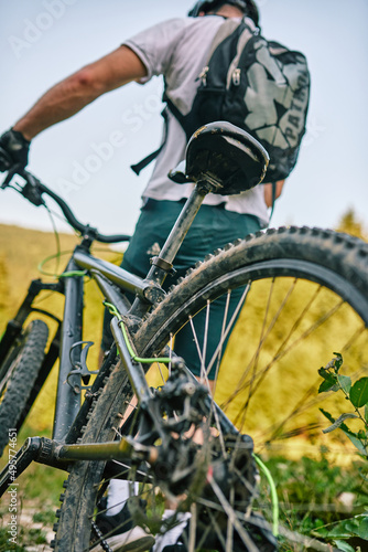 Cyclist Riding the Bike on the Trail in the Forest. Man cycling on enduro trail track. Sport fitness motivation and inspiration. Extreme Sport Concept. Selective focus