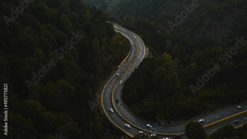 Aerial view of road in the middle of green mountains