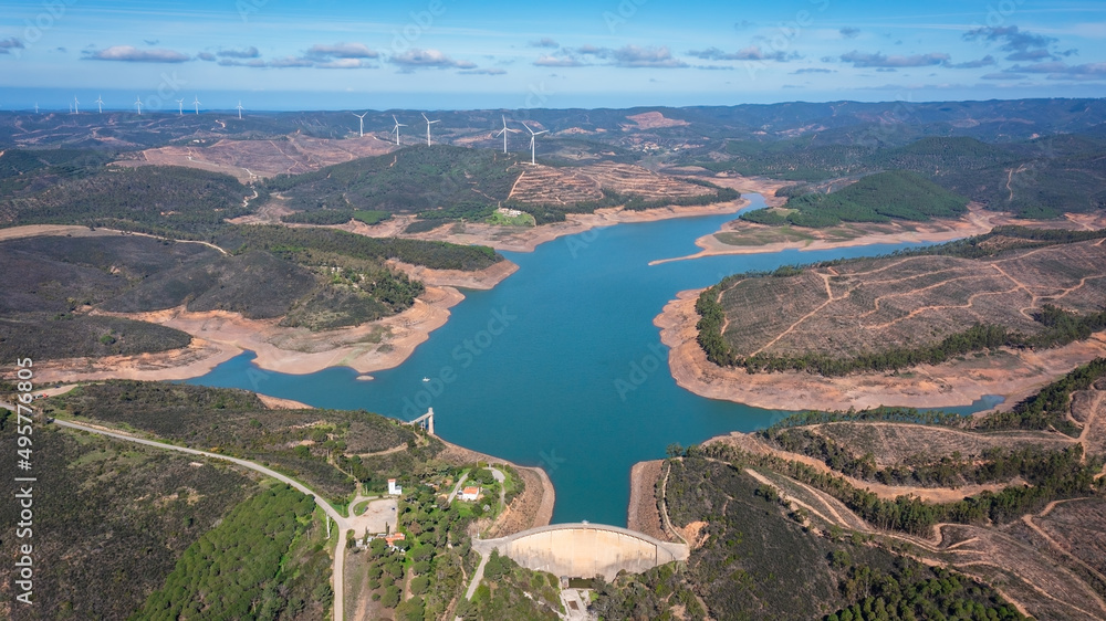 Aerial. Photo from sky, dams filled with water Bravura Portimao. in background, a park of wind generators for clean ecological electricity.