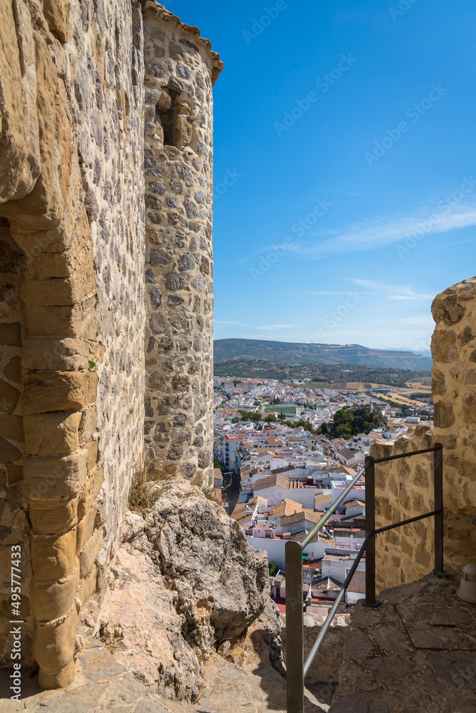 View of the medieval castle in the top of the mountain above the beautiful white village of Olvera, Cadiz province, Andalusia, Spain
