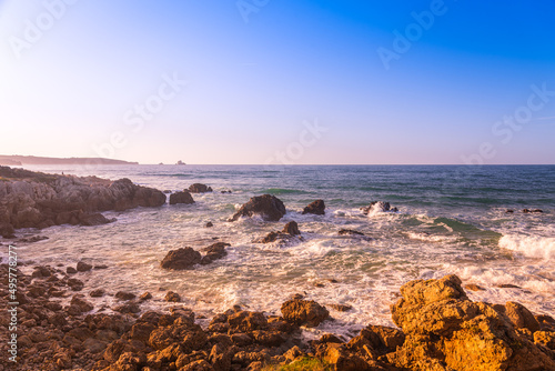 Rocks on the shore of the famous surfing beach of Canallave at sunset, Dunas de Liencres Natural Park and Costa Quebrada, Cantabria, Spain photo