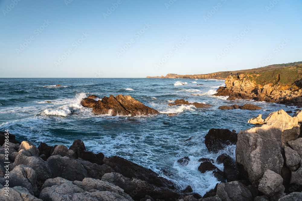 Rough sea water at famous Canallave surf beach at sunset, Dunas de Liencres and Costa Quebrada Natural Park, Cantabria, SPAIN Rough sea water at famous Canallave surf beach at sunset, Dunas de Liencres and Costa Quebrada Natural Park, Cantabria, SPAIN