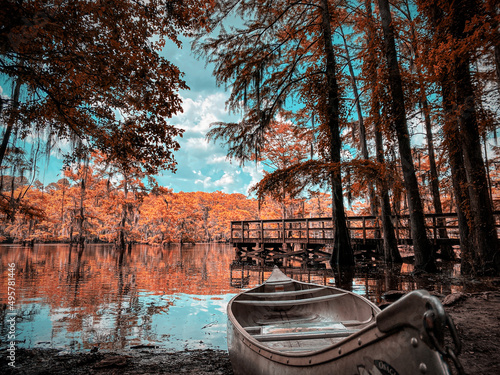 Wooden boat on the shore of the Caddo lake in fall photo