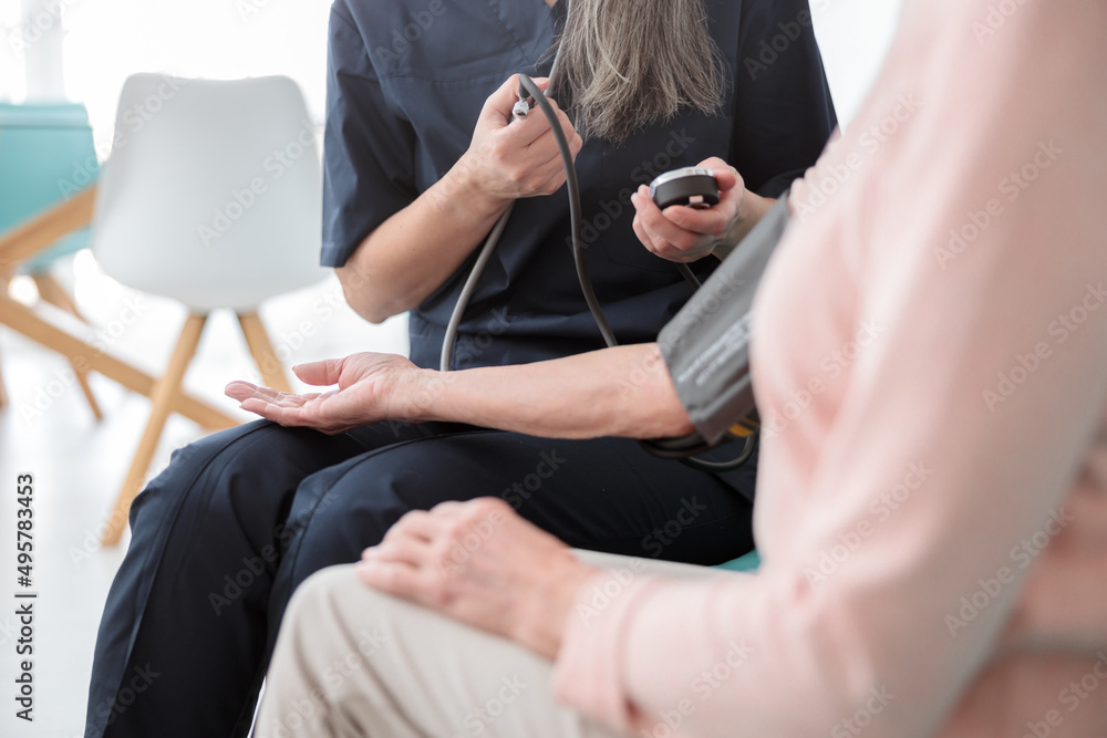 Female pediatrician visiting old woman at home Female pediatrician visiting old woman at home