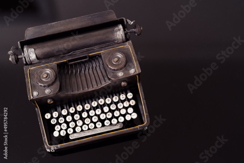 Old typewriter on black glass background. Mock up ready for design